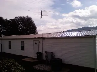 New metal roof on a single wide mobile home with a TV antenna in Barrington