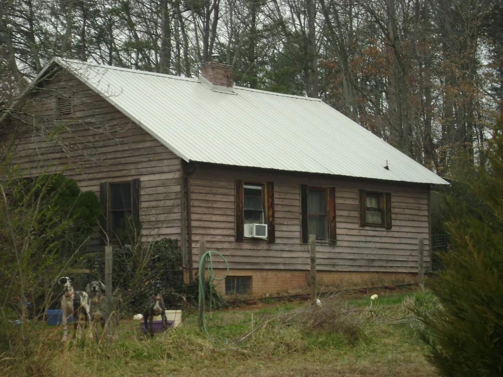 White metal roof on an old wood sided farmhouse, from a Metal Roof Installation job in Barrington